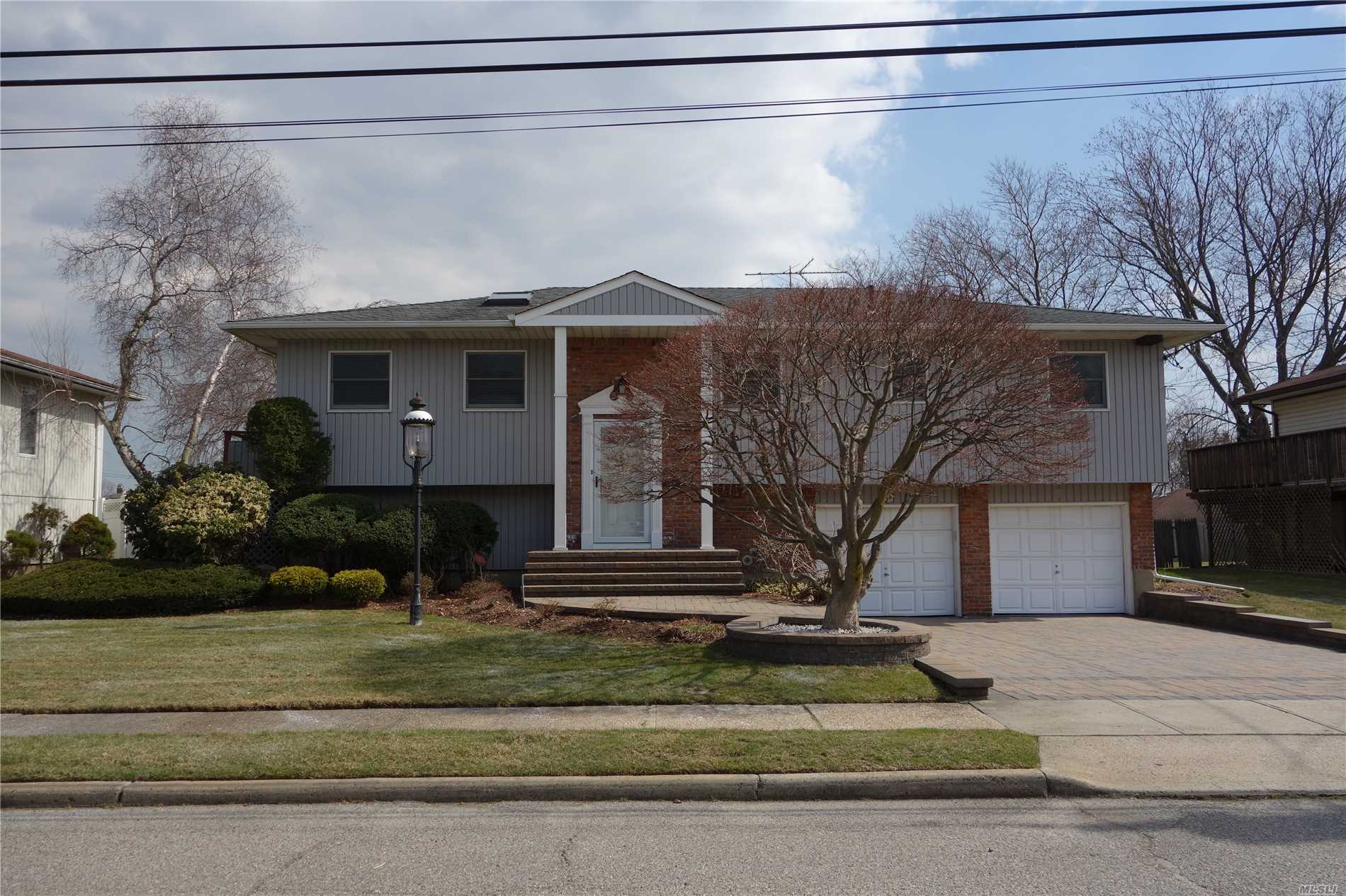 Beautiful, Bright And Spacious 4-Bedroom-3 Full Baths Hi-Ranch With Newer Roof, Siding, And Designed Driveway, Totally Renovated Kitchen With Ample Cabinet Space Granite Countertop And Island, And A Lower Level Having A Separate Entrance.