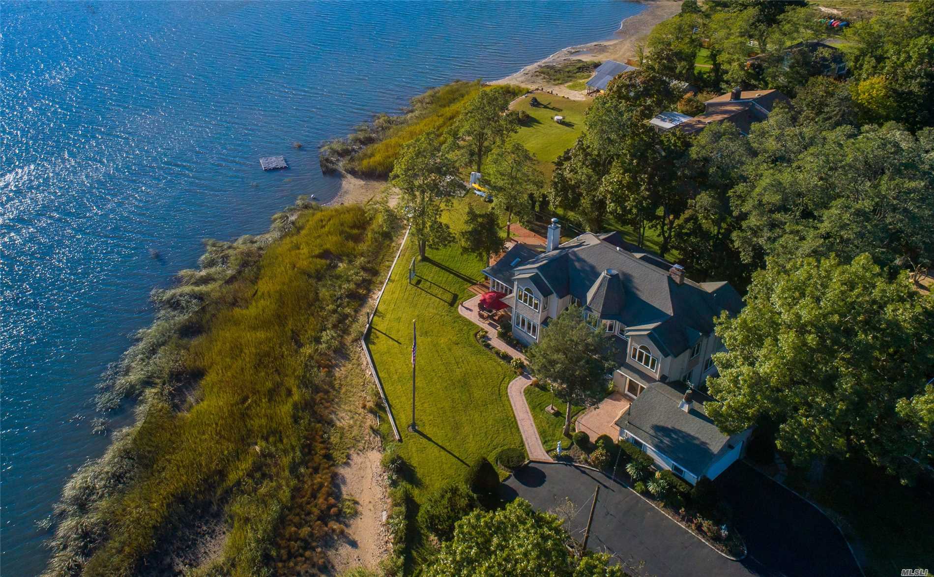Views of the Harbor stretch endlessly from most every room. This amazing bay front property has large picture windows and doors that open to a soft grassy lawn overlooking picturesque Mill Neck. Warm wood finishes, lofty ceilings, a wood-burning fireplace and open spaces to gather and entertain lend charm and grace to this compound.