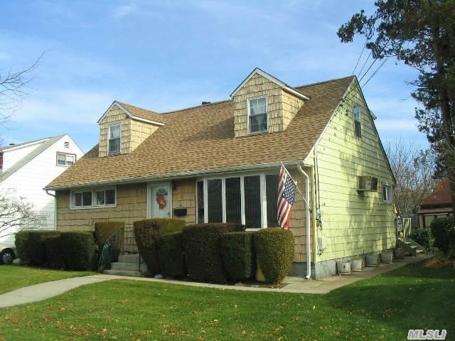 Rear Dormered Cape In North Hicksville. Home Features 4 Bedrooms,  2 Full Baths,  Full Finished Basement,  Lr/Dr,  Updated Kitchen With Gas Cooking. Sliders Out To Rear Deck. Full Part Finished Basement With Utility Area. Wood Floors,  Seperate Hot Water Heater.