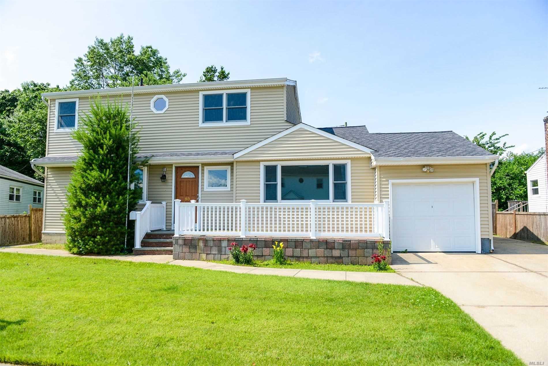 PLAINVIEW. Updated Home In Mid-Block Location. With Open Flow And Incredible Renovations Throughout - Featuring 4 Bedrooms and 3.5 Baths, Bright And Open Updated Eat In Kitchen With Stainless Steel Appliances, Updated Bathrooms, Wood Floors Throughout, Full Finished Basement and Much More!