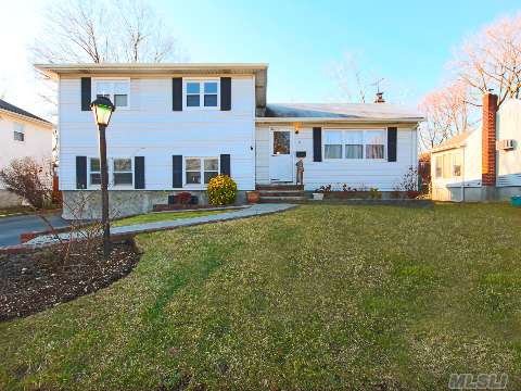 Spacious Split, Possible Mother-Daughter, Priced To Sell, Needs A Little Tlc ,4 Bedroom,  Converted Garage, Covered Redwood Deck, Oversized Back Yard. Gas Heat And Cook, Great Possibilities  Easy Commute Close To Parkways And Bethpage Train Station.