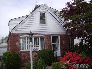 Charming, Bright And Warm Brick Cape In Mid-Block Location Across From Park, Living Room, Large Eat-In-Kitchen, 4B, 1.5 Baths. Room To Make Half Bath Into A Full Bath. Porch Off The Master Bedroom. There Is Hardwood Floors Throughout The House. The Basement Is Half Finished With A Wet Bar. This House Offers Updated Windows And Rugs. Close To Schools, Park, Library.