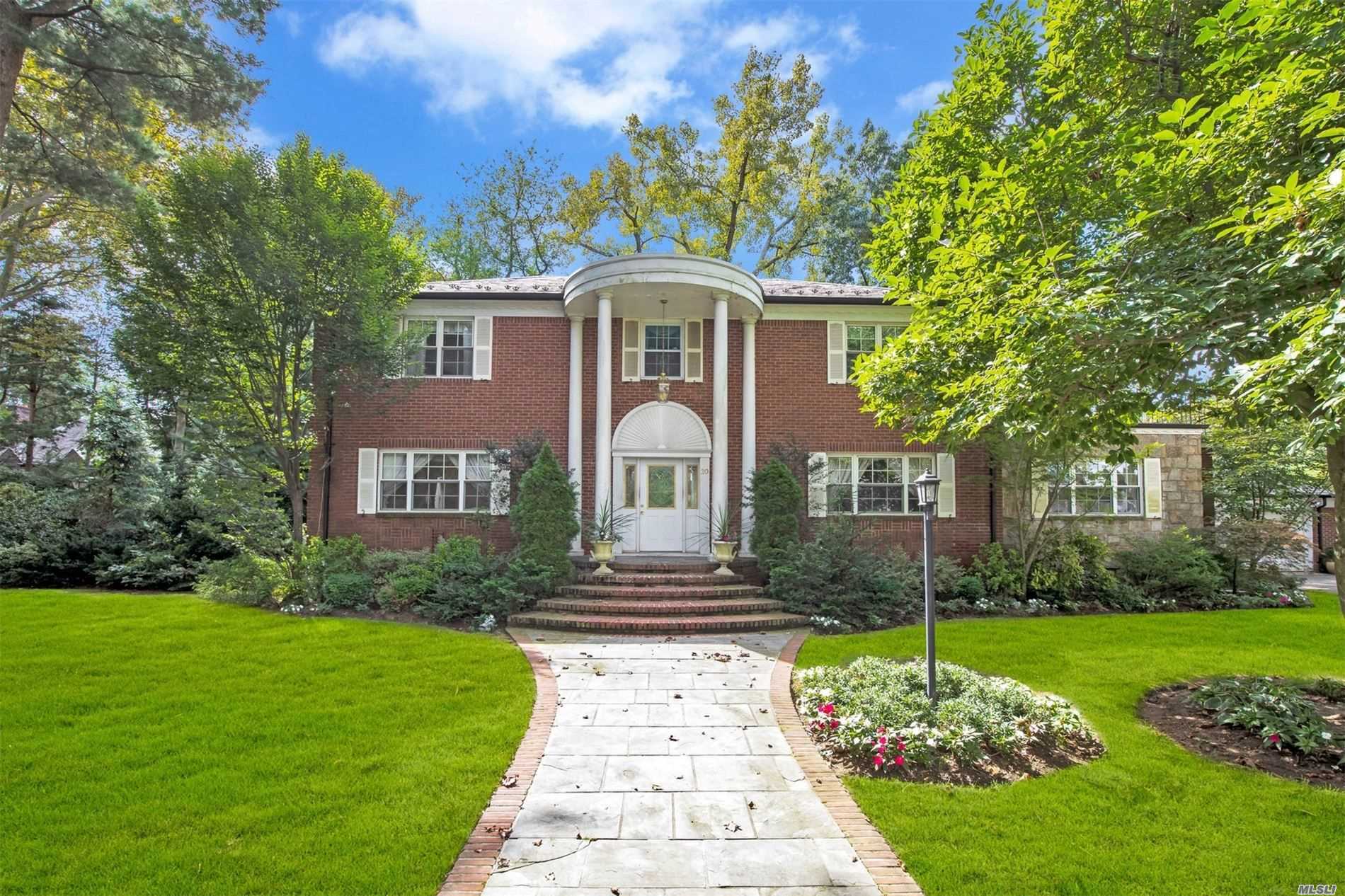 Handsome brick colonial located in prime University Gardens. Four bedrooms, 4 full baths, spacious master en suite, formal corner living room with FPLC, formal dining room, modern eat-in-kitchen with separate breakfast room overlooking private yard, sun room, attached 2 car garage, .41 Acres in total.