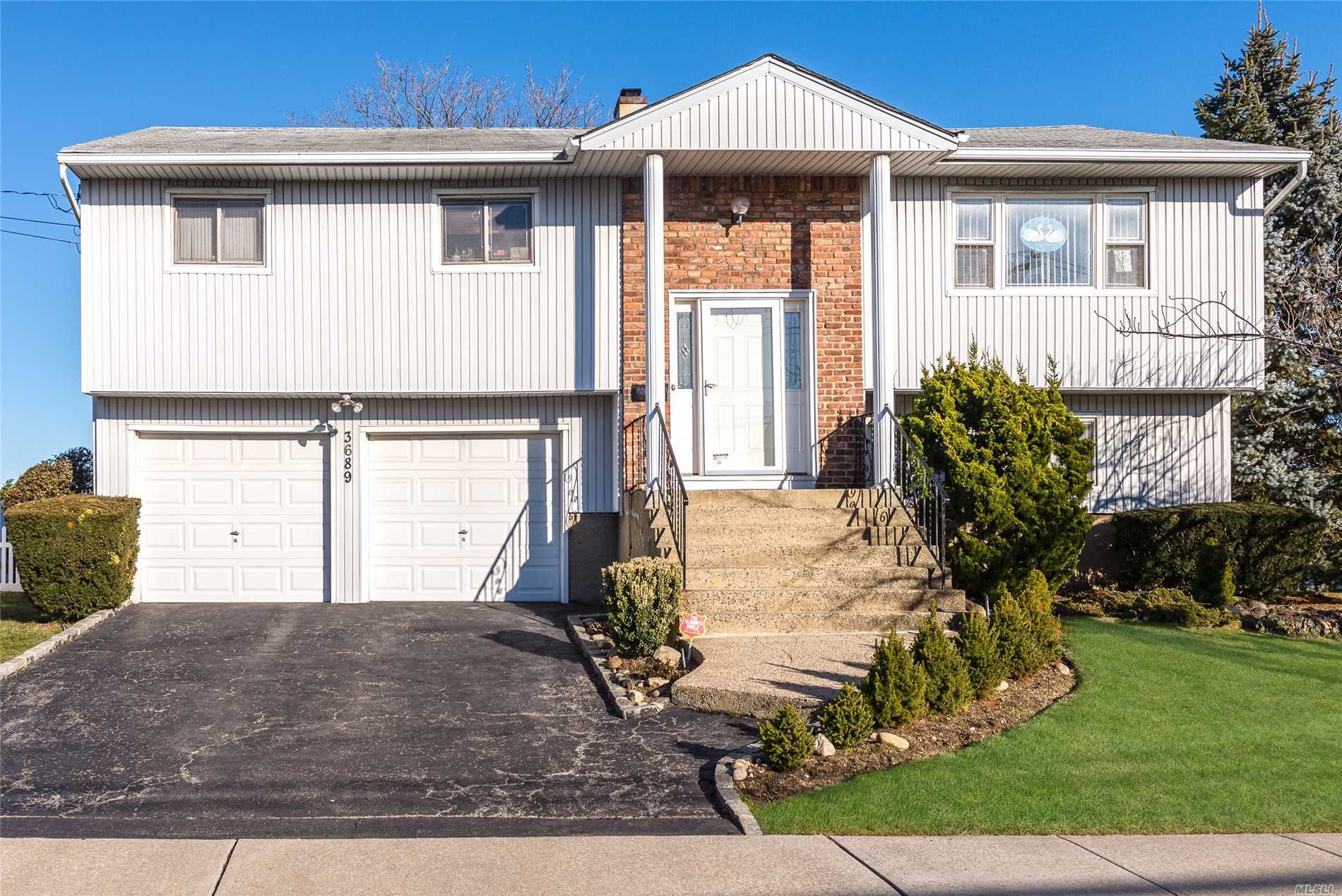 New To The Market. 8 Room Wide-Line Hiranch Located In The Madison Section Offers 4 Bedrooms 2 Full Bathrooms Rear Wood Deck Off Eik, Hardwood Floors On The Upper Level, 2 Car Garage And 6 Zone In Ground Sprinklers. Only Minutes From Shopping And Lirr.