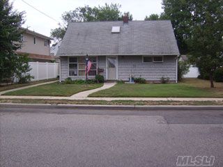 Expanded Cape Featuring An Open Floor Plan, Skylights, Private Fenced In Backyard And Mid-Block Location. Centrally Located With Access To Beaches,Recreational Parks, Parkways And Other Transportation,Cultural Attractions. Shopping And Educational Institutions. Easy Commute Into Nyc. This Spacious Home Is Awaiting Your Arrival.It Begins By Taking The First Step.