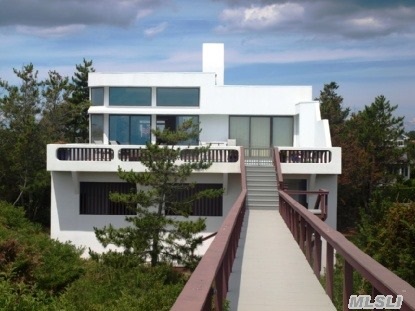 This Prestigious Quogue Oceanfront Home Boasts Spectacular Ocean Views. There Are Additional Waterviews Of The Quogue Canal. The Interior Gallery Style,  With Soaring Ceilings,  Is An Art Lovers Dream. This Pristine Home Features 5 Bedrooms,  6.5 Baths,  And Huge Open Living Spaces. The Coral Floors & Fireplace Are Breathtaking.