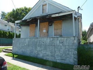 Calling All Investors! Large Flat Piece Of Property. Quiet Area On The Border Of Glen Cove & Locust Valley. 2 Bedroom House With A Small Area Of Fire Damage In The Front Part Of The House. Easily Fixable With A Small Investment. Detached Garage With Loft Space.