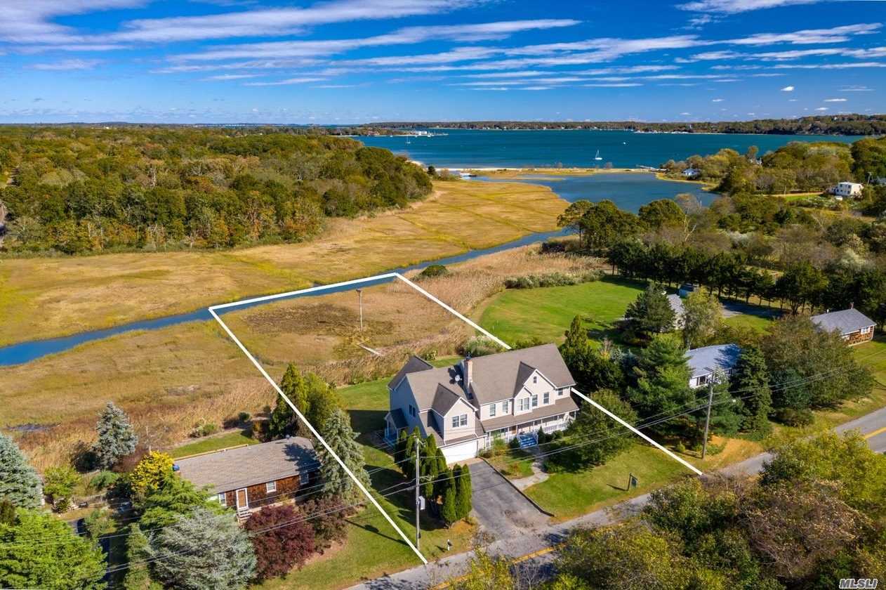 This Panoramic Water View 5 Bedroom home includes an accessory apartment in Peconic Bay Estates - located less than 2 miles from Greenport Village. 2005 complete renovation includes two kitchens, master suites on both floors, Great rooms, hardwood flooring, a fireplace and much more. Picturesque natural setting with unobstructed views to Shelter Island and the ferries. Beautiful lawn and yard area. Kayak/paddle board access out to Peconic Bay.