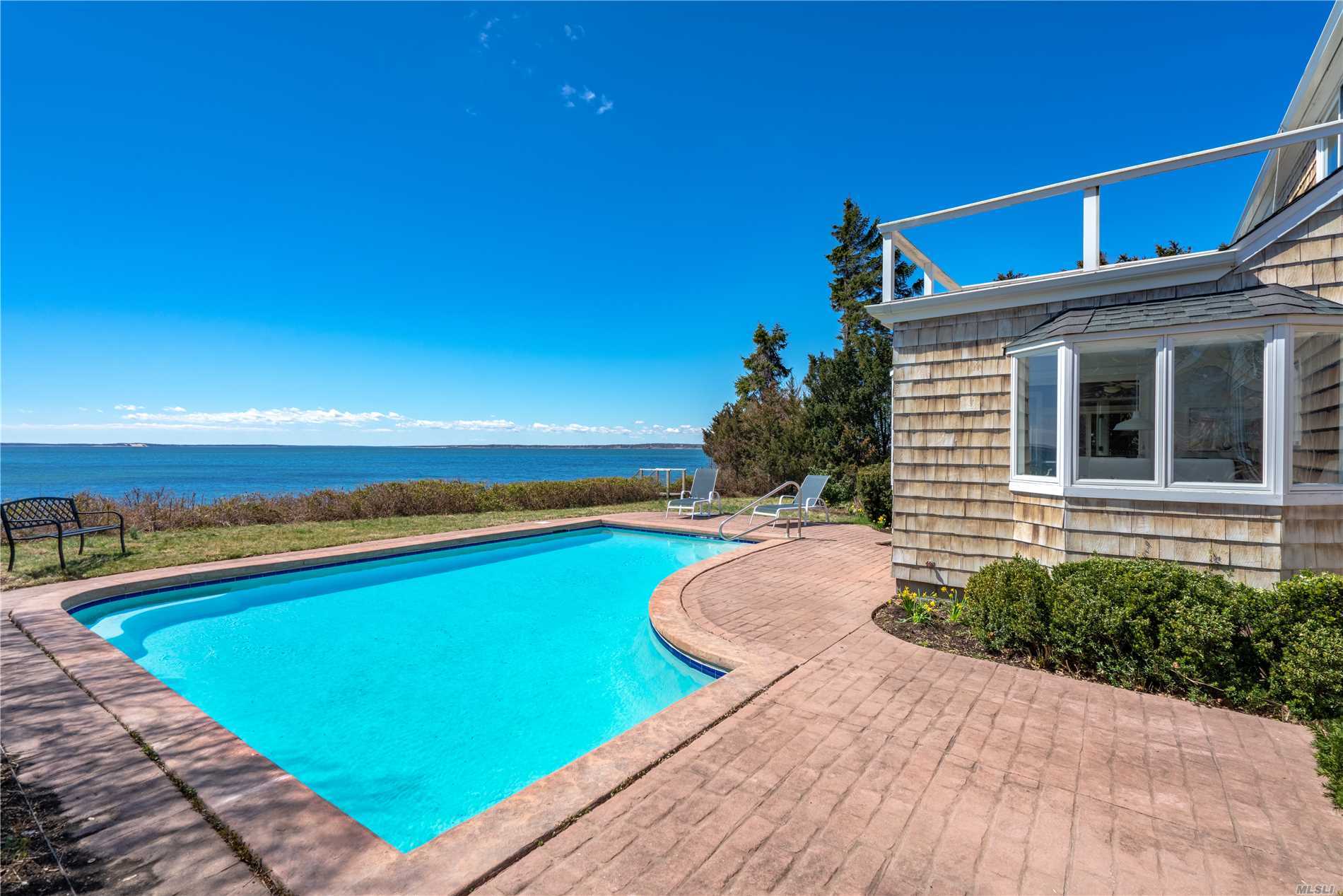 Dreamy 1930&rsquo;s cape on Peconic Bay with stunning views from Jessup&rsquo;s Neck to Nassau Point. The water side pool, privacy, charm, 4 bedrooms, 2 full baths, detached garage, full basement and all updated mechanicals makes this property the complete package for any serious bay front buyer. Fully bulk headed low bluff stairs lead to 100 feet of private sandy beach and shared dock in community docking area. Bay front beauty.