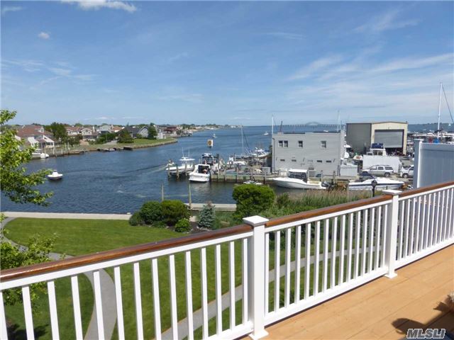 Elegant 3 Bedroom, 3.5 Baths Waterfront Townhouse. Master Suite W/ Jacuzzi Tub. Beautiful Elevated (15Ft) End Unit With 2 Car Garagre, Additional Windows And 2 Large Decks Plus 30' Deeded Dock. Personal Elevator For Access To All Three Levels. Located On 300' Wide River With View Of Great South Bay And Bridge.