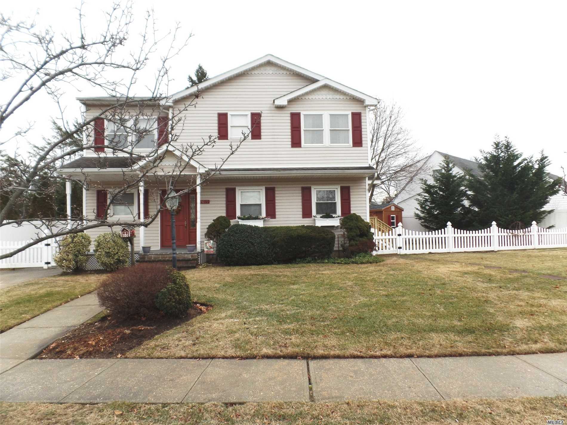 Updated Colonial. Great Curb Appeal. Cozy Front Porch. 1st Flr: Gleaming Hardwood Flrs, Eik, Fdr W/Slider To Paver Patio & Fully Fenced Yard, Lr, Den/Home Office W/Outside Entry (Easily Conv Back To Open Flr Plan), Full Ceramic Tiled Bath. 2nd Flr: 4 Bdrms, Oversized Hall Bath W/Jacuzzi Tub. Full Finished & Heated Bsmt. Laundry & Utility Rm. 200 Amp Elec, Igs, Seaford Sd#6