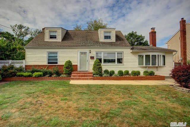 This Great Cape Features 4 Bedrooms , Updated Roof & Siding. Hardwood Floors.  Open,  Airy & Bright Family Room W/Fireplace & Skylight.  Dining Area Has Sliders That Open To A Large Deck Leading To An Oversized Fully Fenced Yard.  Partially Finished Basement.