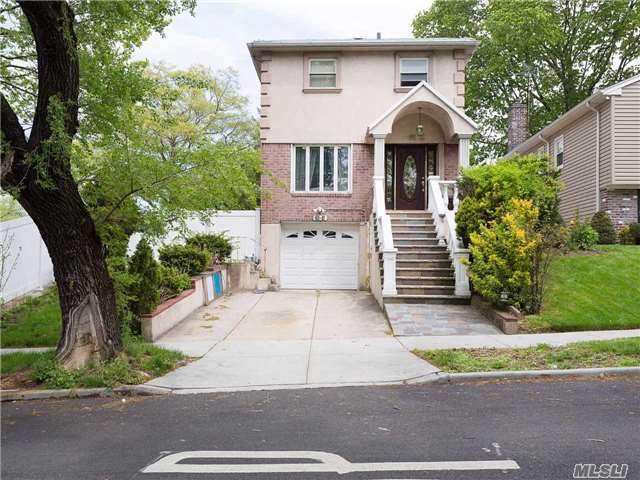 Lovely Brick And Stucco Detached Colonial On A Lovely Tree-Lined Street In A Desirable Section Of Bayside. This One Family House Features Three Bedrooms, Two Full Baths, Finished Basement, Backyard With Deck, And One Car Garage With Private Driveway. Zoned For School District 26 With Nearby Schools P.S. 46, And M.S. 74. Quick Access To Public Transportation And Major Hwy.