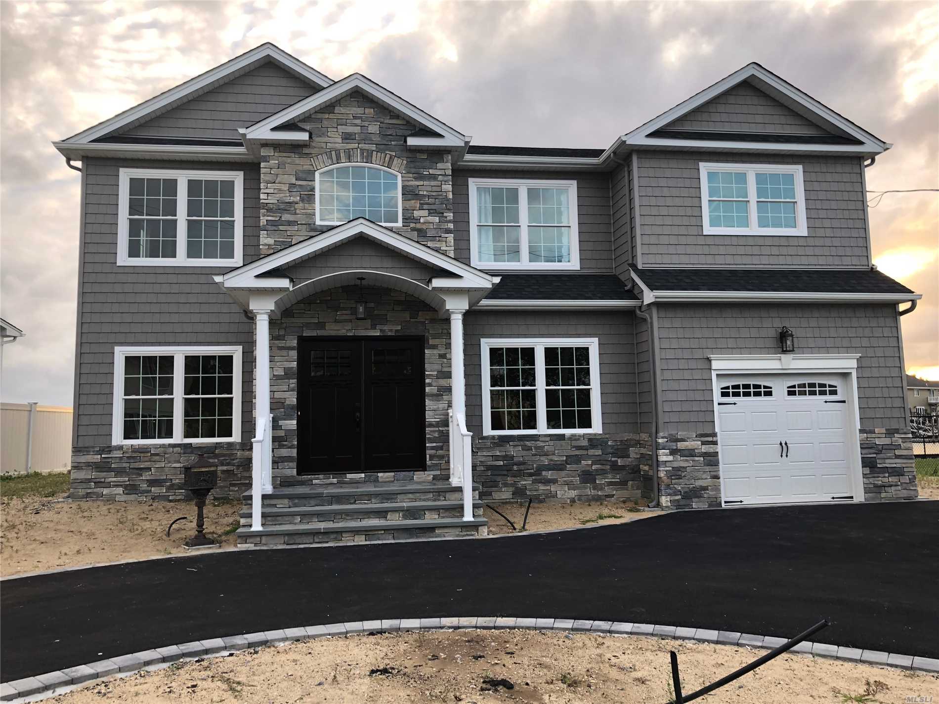 Brand-New Custom *Waterfront* Center-Hall Colonial Being Built In The 1st-Class Massapequa Shores Neighborhood & On Pristine Block Filled W/ Nice Homes! Built By Builder Of 30+ Yrs/350+ Homes. Home Features: Custom Kitchen & Vanities W/ Ss Prof Appliances, Pella Wdws, Sophisticated Moldings Throughout, 1.5-Car Gar, 1st Flr Bdrm/Office, 3 F-Baths, & Large Master Suite W/ Balcony & 2 Wic&rsquo;s & Fbath+Jacuzzi, +++Much More!
