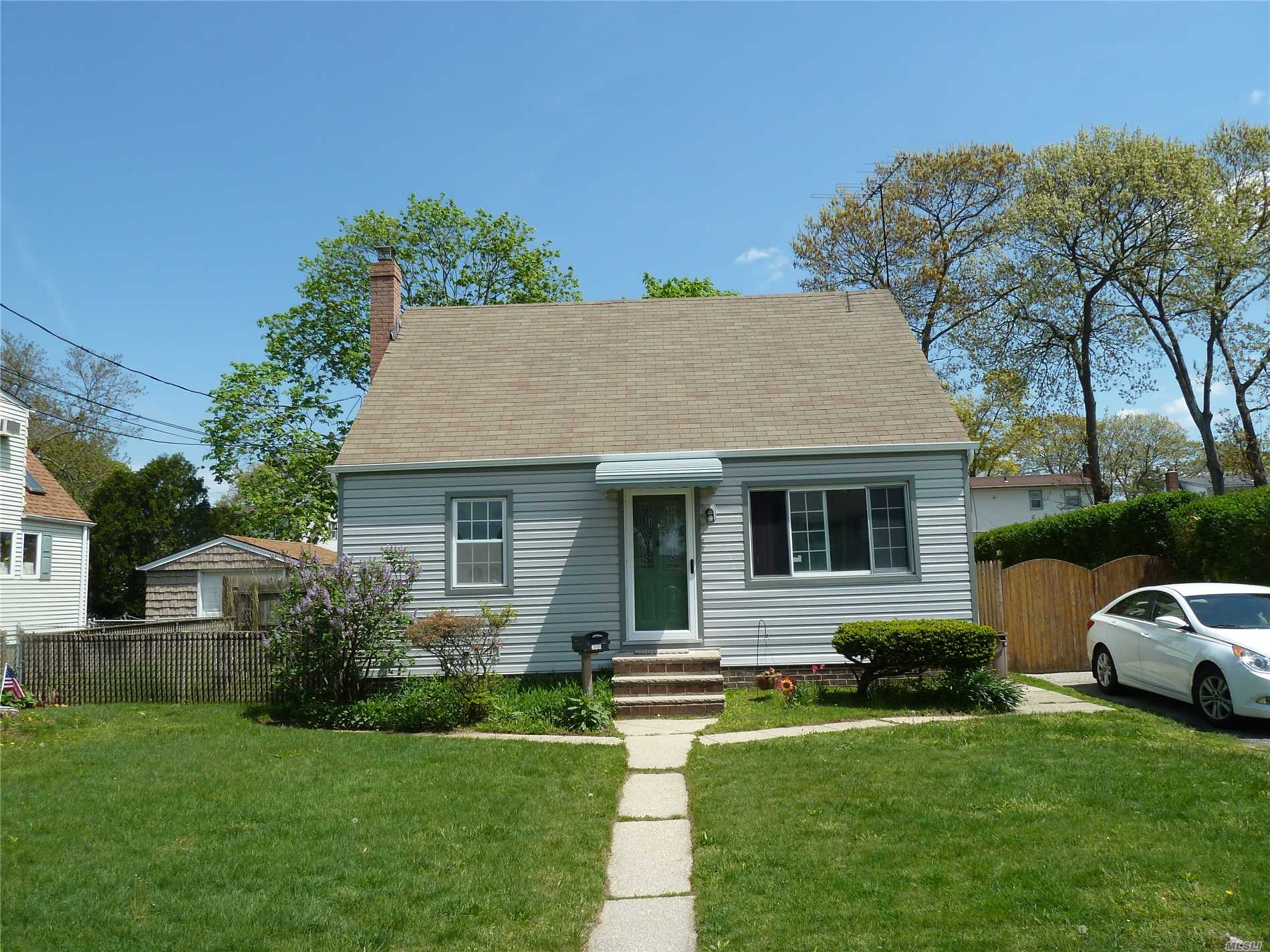 Lindenhurst Village Cape Has Hard Wood Floors, 150 AMP SVCE, Full Basement With Separate Outside Entrance, Detached 1 Car Garage, 2 Zone Heaters With Separate Hot Water Heaters. Roof Is 9-10 Years Old, Boiler 6-7 Years Old, 5 New Windows. Great Potential. Needs TLC.