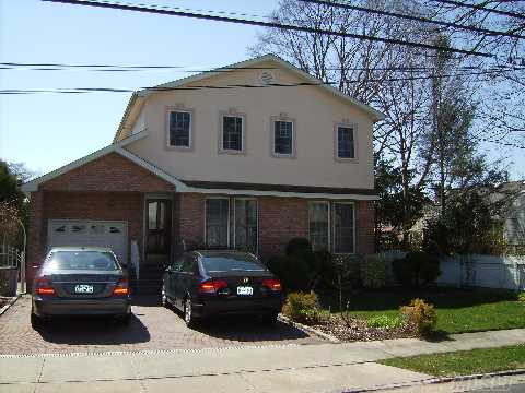 Mint Condition Brick And Stucco Colonial With Brick Pavers In Driveway, Entry Hall Leads To Elegant And Generously Sized Living Room, Large Den With Wood Burning Fireplace, Wood Deck Off Den, 4 Bedrooms, 2.5 Baths, Mid-Block Location, Roslyn Schools