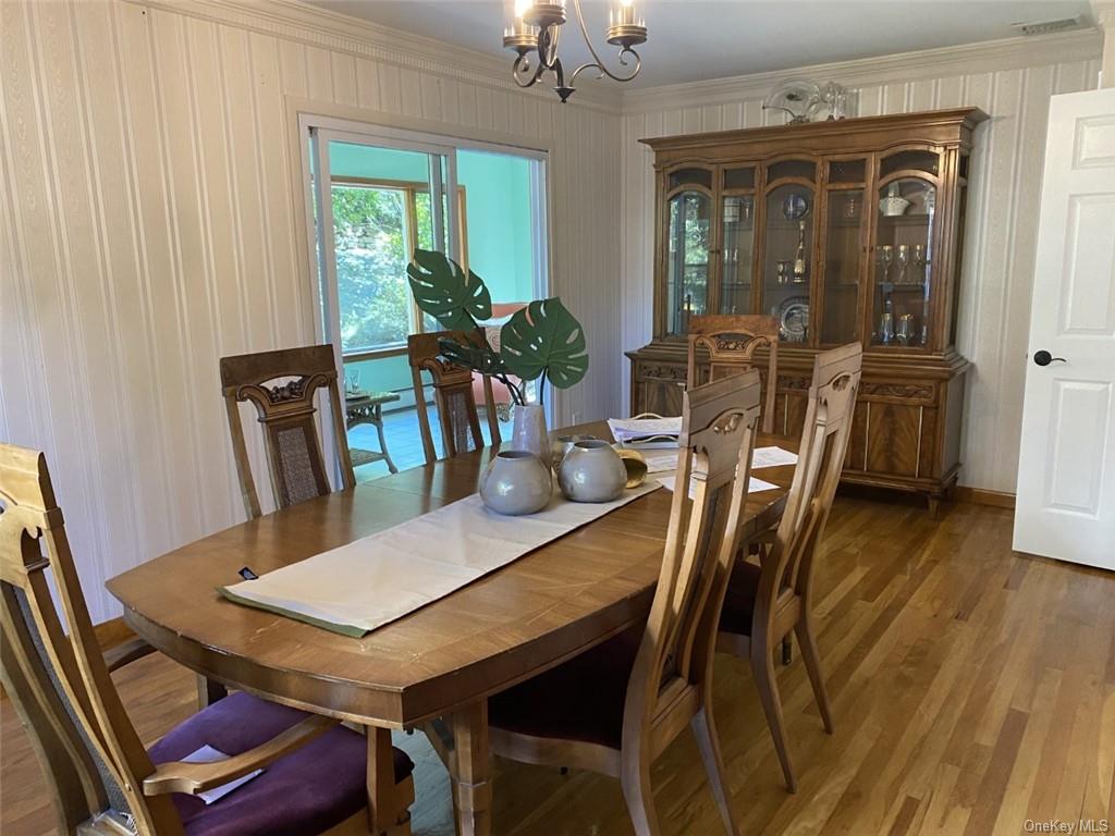 Opening to the sunroom, the large formal dining room easily accommodates guests, friends, & family.