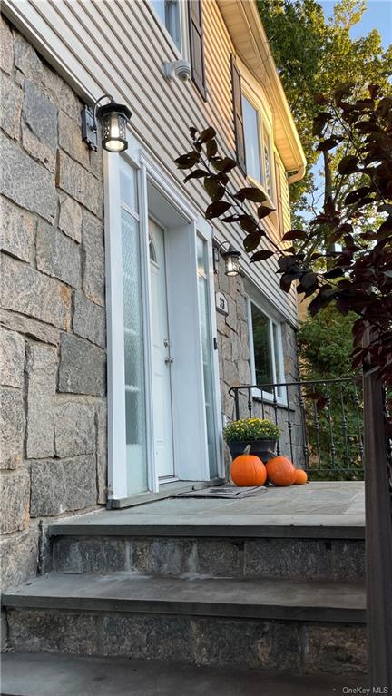 Accented by impressive stone work - front facade, stairs, and retaining wall.