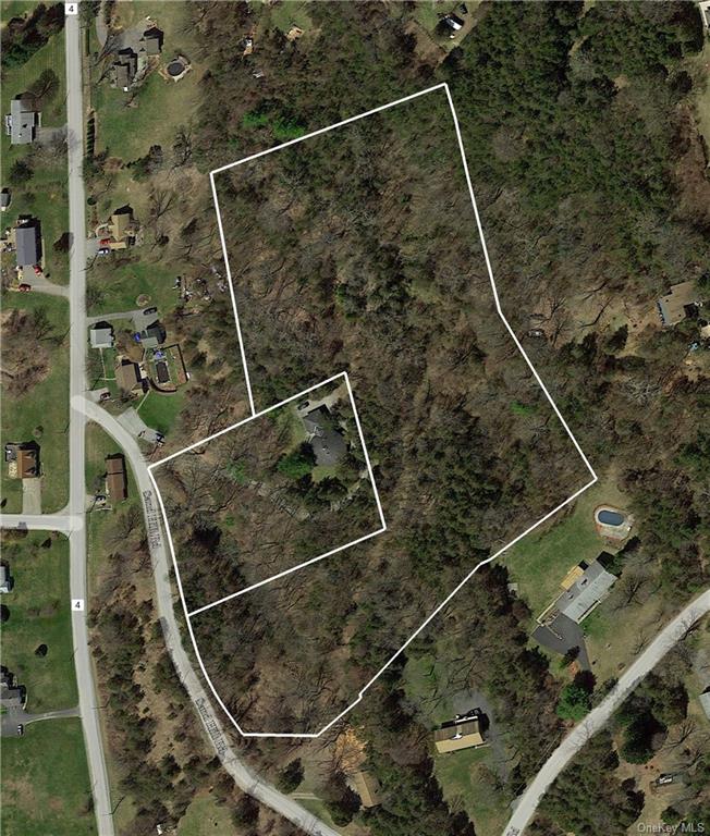 Mostly surrounding the home parcel stretches a separate included parcel of over 7 acres of woods with tons of potential.